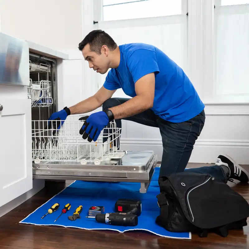 Plumber fixing a dishwasher