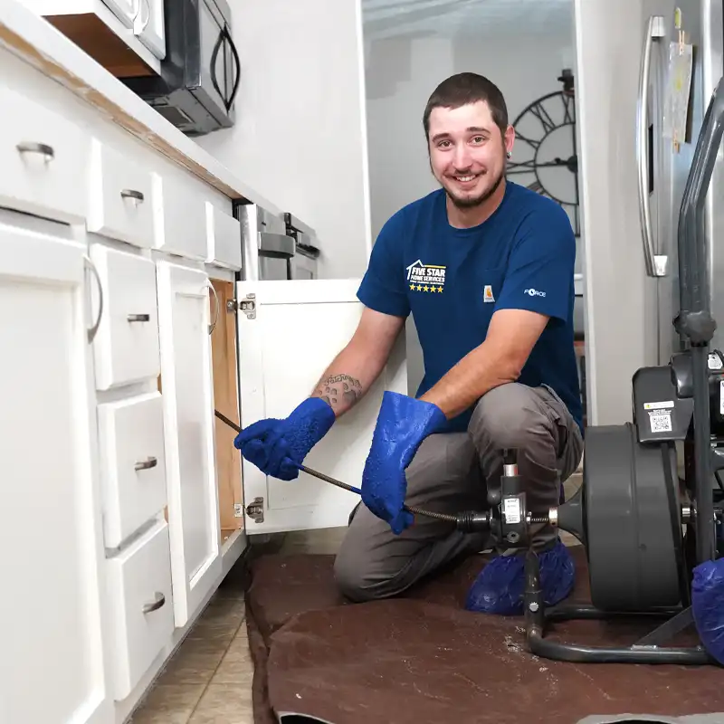 plumber fixing a garbage disposal