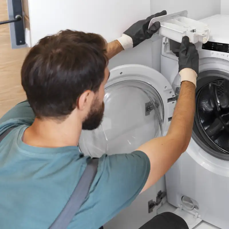 Plumber fixing a dishwasher