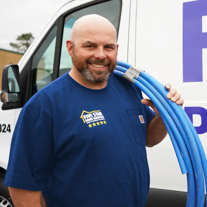 Plumber holding sewer line pipes